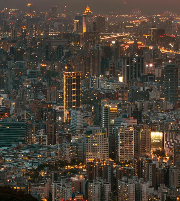 This is an expansive, high-angle extreme wide shot capturing a vast cityscape at