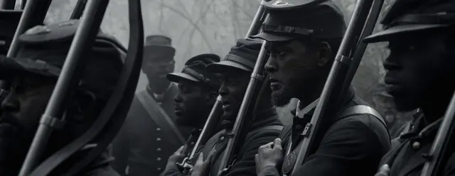This shot profoundly captures a line of resolute soldiers, focusing sharply on a