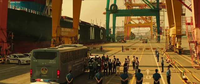 This wide shot captures an expansive industrial port under the warm glow of late
