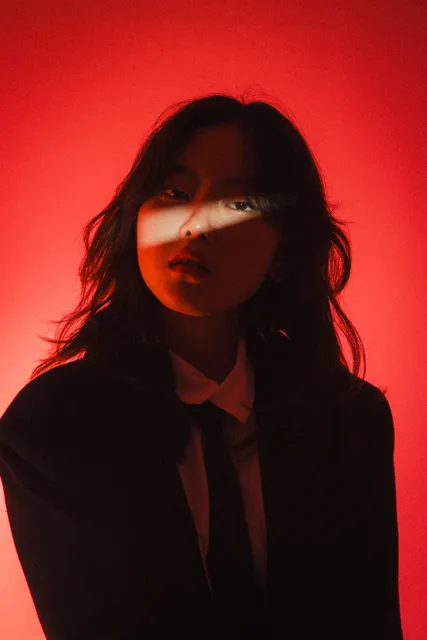 This shot is a striking portrait that uses a bold, monochromatic red palette and