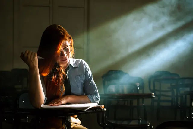 This shot masterfully uses dramatic lighting to create a pensive and atmospheric