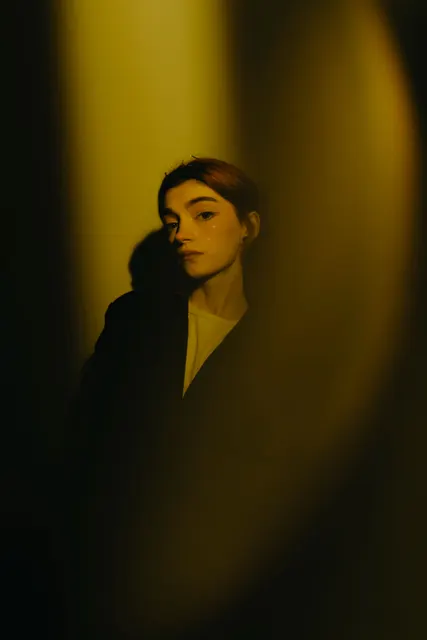 This shot uses a dramatic interplay of hard, directional light and deep shadow t